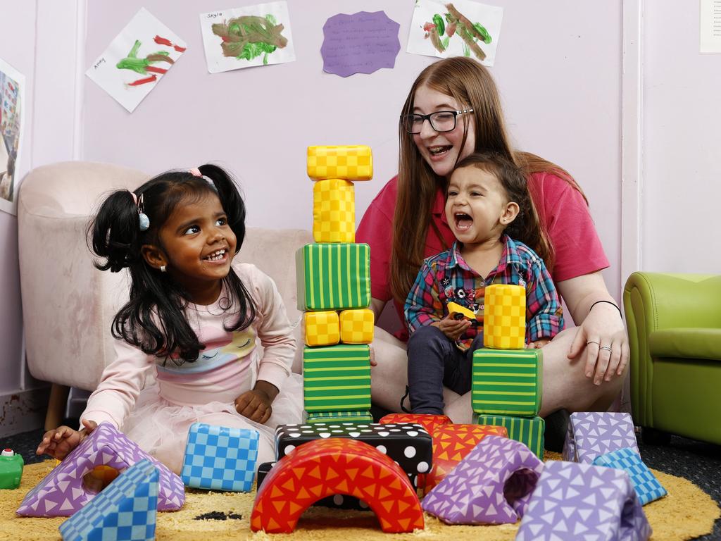 Childcare worker Hannah Joy with Skyla, 2, (left) and Naira, 1, at Clovel Child Care &amp; Early Learning Centre in Wentworthville. Picture: Jonathan Ng