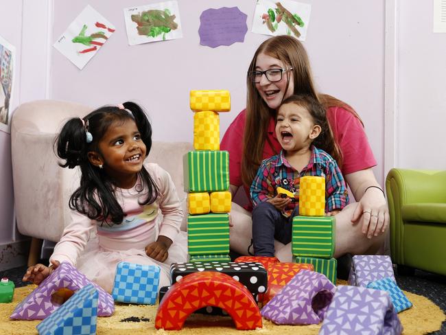 Childcare worker Hannah Joy with Skyla, 2, (left) and Naira, 1, at Clovel Child Care &amp; Early Learning Centre in Wentworthville. Picture: Jonathan Ng