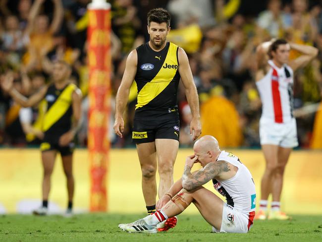 Cotchin goes to check on Jones. (Photo by Michael Willson/AFL Photos via Getty Images)