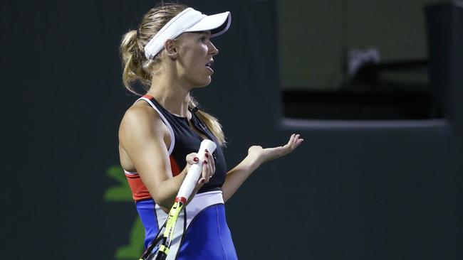 Caroline Wozniacki, of Denmark, questions the chair umpire about noise during her match against Monica Puig, of Puerto Rico, at the Miami Open tennis tournament early Saturday, March 24, 2018, in Key Biscayne, Fla. Puig defeated Wozniacki 0-6, 6-4, 6-4. (AP Photo/Wilfredo Lee)
