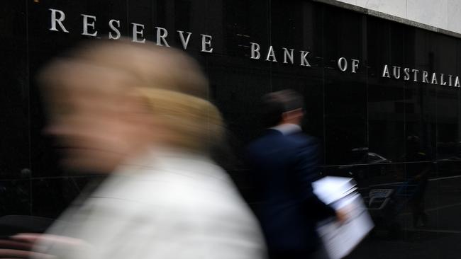 A pedestrian walks past the Reserve Bank of Australia building in Sydney. AAP Inamge