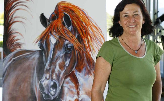 Marina Izatt stands next to Big Red by Jill Vanstone, which will be on display at Bunyip Scenic Rim Resort as part of an art show by local artisans. . Picture: Claudia Baxter