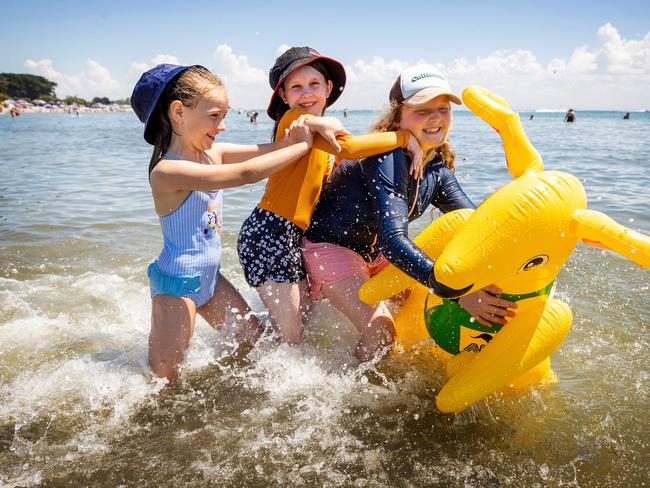 Sophie, 6, Mia, 12, and Ruby, 11, show their Aussie spirit with the boxing kangaroo at Portarlington. Picture: Mark Stewart