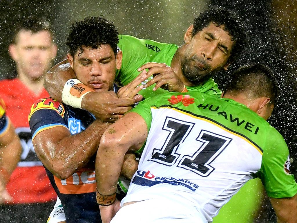 GOLD COAST, AUSTRALIA - MARCH 17: Brian Kelly of the Titans is tackled during the round 1 NRL match between the Gold Coast Titans and the Canberra Raiders at Cbus Super Stadium on March 17, 2019 in Gold Coast, Australia. (Photo by Bradley Kanaris/Getty Images)