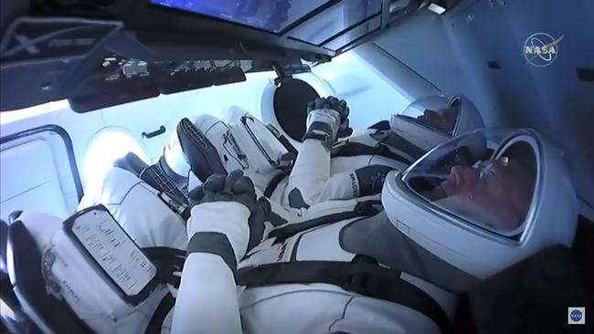 In this still image taken from NASA TV, NASA astronauts Bob Behnken (rear) and Doug Hurley are strapped in the SpaceX Crew Dragon capsule at Kennedy Space Center in Florida for their launch to the International Space Station.