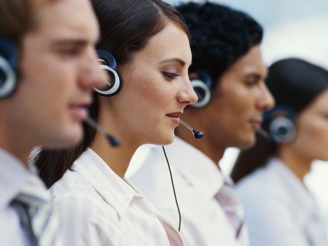 Young men and women working in call centre. Must credit Thinkstock