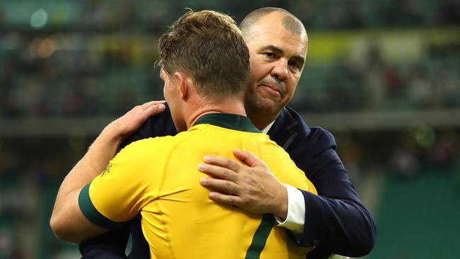 Wallabies coach Michael Cheika hugs captain Michael Hooper after the quarter-final loss to England. Picture: Getty Images