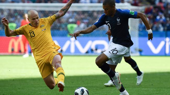 Aaron Mooy lunges for the ball against France’s Kylian Mbappe. Picture: AFP