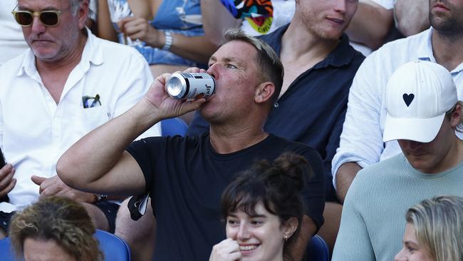 Shane Warne enjoys a drink at the Men's Final. Picture: Getty Images