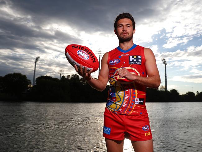 GOLD COAST, AUSTRALIA - AUGUST 18: Suns player Jarrod Harbrow poses wearing the Indigenous Guernsey  designed by local Yugambeh man Luther Cora. on August 18, 2020 in Gold Coast, Australia. (Photo by Chris Hyde/Getty Images via AFL Photos)