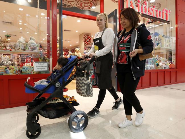 Nanny Maryann Spaccavento helps Ni Zeng with her baby Brendon Ruitteng as part of the Shopping Nanny service. Picture: Daniel Munoz