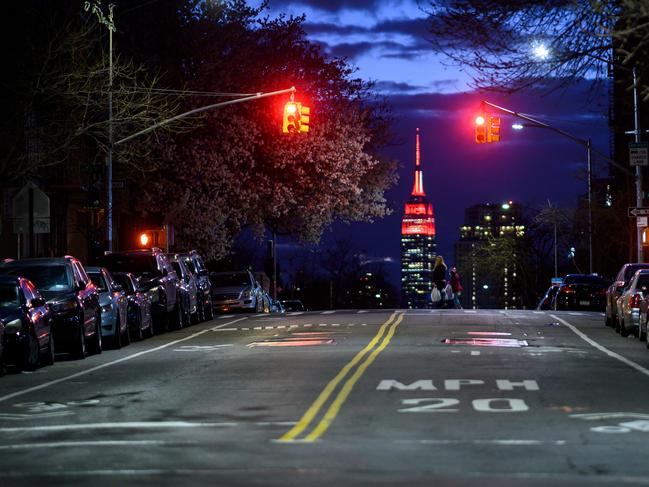 The Empire State Building building is lit with a white and red “siren” in its mast to pay tribute to medical workers battling the coronavirus outbreak. Picture: AFP