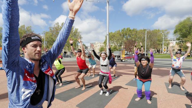 Michael Brennan leads the Mobart Mo Bros in Movember yoga. Picture: RICHARD JUPE