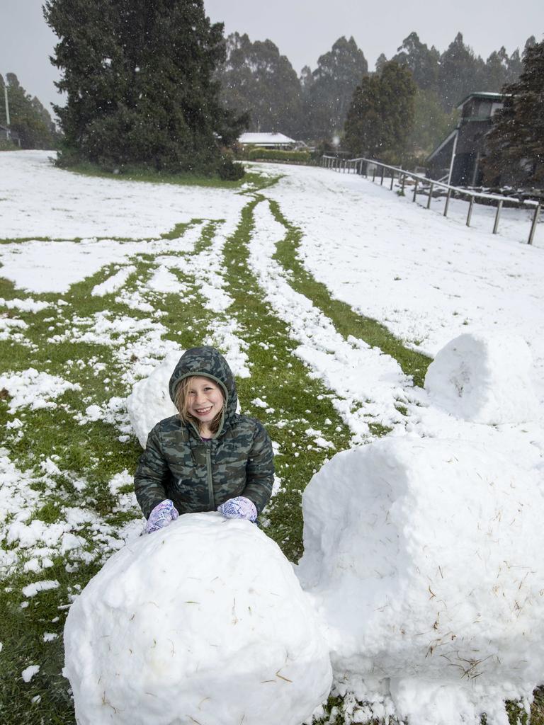 Lizzy (8) celebrating the latest Spring snow at home at Ferntree. Picture Eddie Safarik