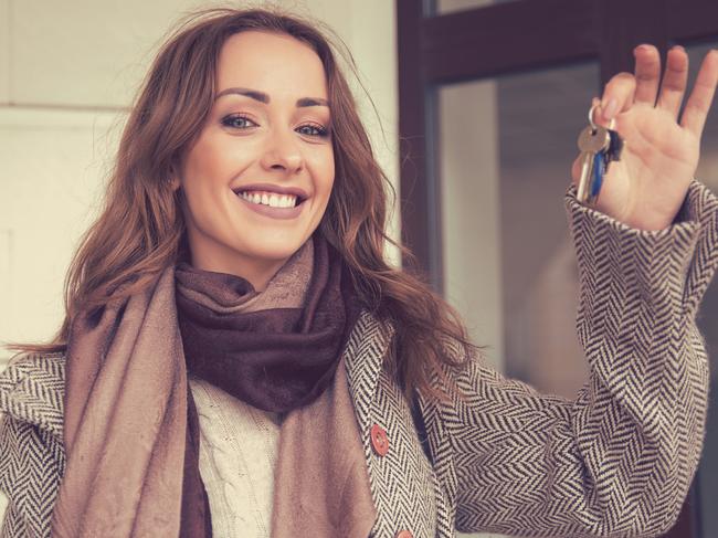 Happy beautiful woman holding keys from her new apartment