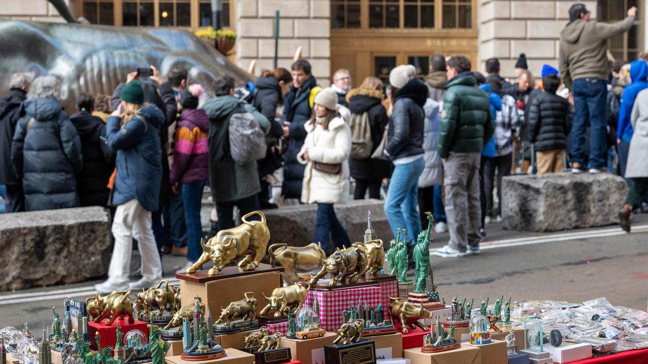 People walk through the financial district by the New York Stock Exchange on the last day of trading for 2023. Picture: Getty Images