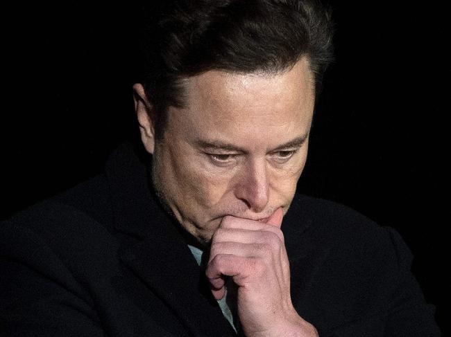 (FILES) In this file photo taken on February 10, 2022 Elon Musk pauses and looks down as he speaks during a press conference at SpaceX's Starbase facility near Boca Chica Village in South Texas. - A Twitter account that tracked flights of Elon Musk's private jet was grounded on December 14, 2022 despite the billionaire's talk of free speech. (Photo by JIM WATSON / AFP)