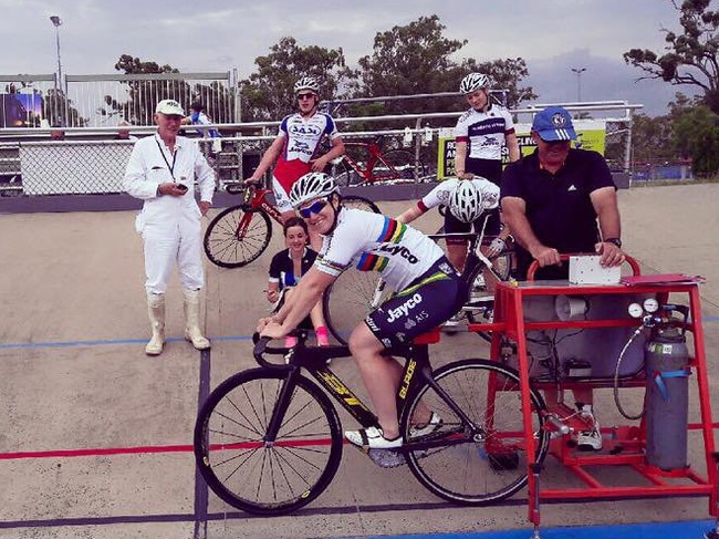 Anna Meares on the track in Rockhampton with local riders and former coach Reggie Tucker.