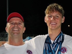 (L-R) Coach Justin Rothwell with Josh Kerr and his collection of six medals from the Australian Championships. Provided: Manly Swimming Club