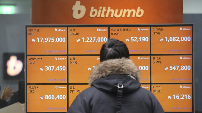 A man watches a screen showing the prices of bitcoin at a virtual currency exchange office in Seoul, South Korea. (AP Photo/Ahn Young-join)