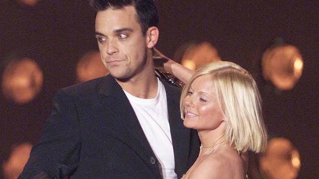 Robbie Williams and Geri Halliwell embrace at the Brit Awards in 2001. Picture: Dave Hogan/Getty Images