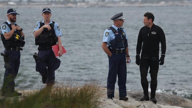 Police and SES volunteers search Yarra Bay for signs of a baby apparently seen in the water. Picture: John Grainger