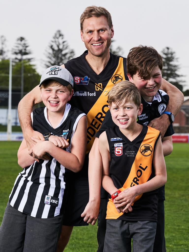 Kane Cornes with his sons, Raph, 11, Sonny, 9 and Eddy, 13 at Glenelg Football Club. Picture: Matt Loxton