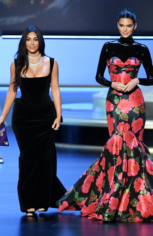 Kim Kardashian West, wearing Vivienne Westwood, and Kendall Jenner (in Richard Quinn) on the Emmys stage. Picture: Getty Images