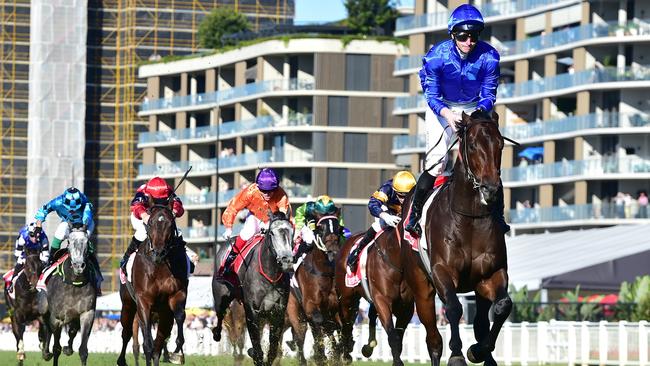 James McDonald high in the irons crossing the line aboard Broadsiding in the Group 1 JJ Atkins Picture: Grant Peters - Trackside Photography