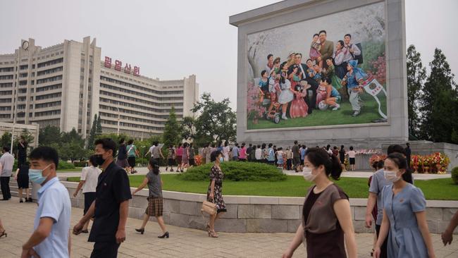 People prepare to pay their respects before portraits of late North Korean leaders Kim Il-sung and Kim Jong-il, on the 27th anniversary of Kim Il-sung’s death. Picture: AFP.