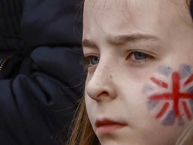 A child, with a Union Jack painted on her face, waits at the Mall to watch the procession during the Coronation of King Charles III. Picture: Getty Images