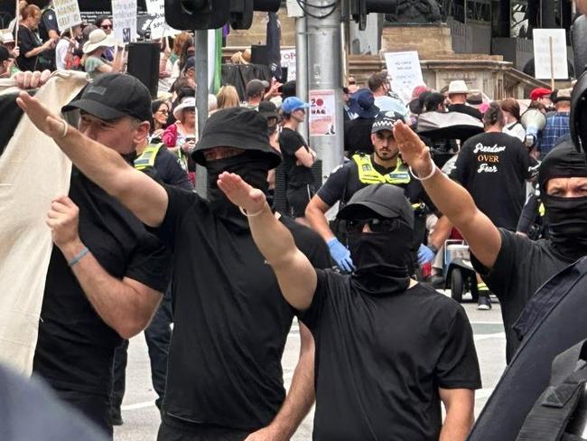 Masked men performed Nazi salutes in Melbourne’s CBD on Saturday. The group of men A melting pot of protest groups clashed at a heated demonstration in Melbourne’s CBD on Saturday. Dozens of activists gathered outside Parliament House .Supplied Twitter