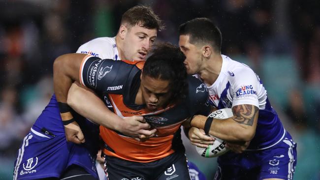 Luciano Leilua is wrapped up by the Bulldogs’ defence. Picture: Jason McCawley/Getty Images