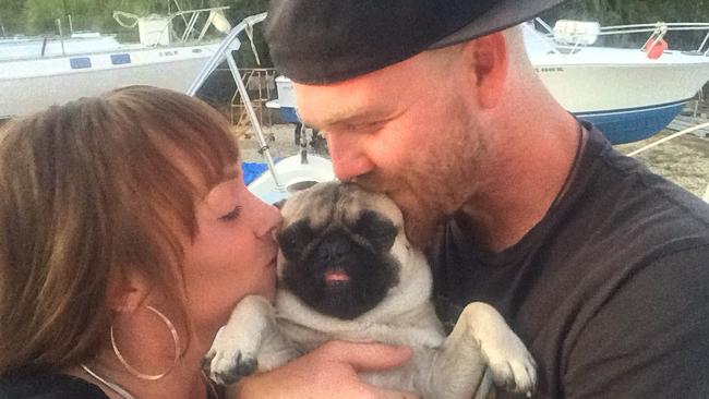 Nikki Walsh and Tanner Broadwell with their pug Remy, lost everything when their boat sank. Picture: Facebook