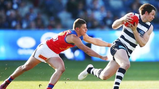 Patrick Dangerfield slips past Dayne Zorko in Round 19 last year. Picture: Michael Dodge/Getty Images.