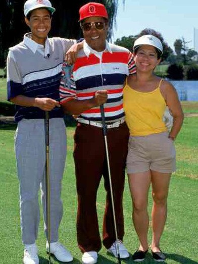 Tiger, aged 14, with his father, Earl, and mother, Kultida. Picture: Getty Images