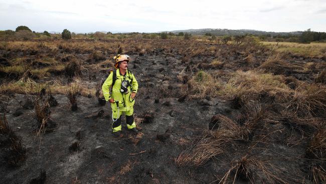 Nerang Station Officer Monty Dayman makes a final check of burnt grasslands at Carrara before wrapping up operations. Gold Coasters have been advised to prepare for the upcoming fire season. Picture: Glenn Hampson.