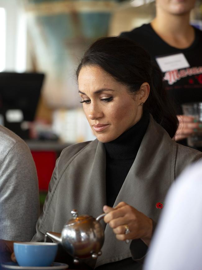 Meghan pours a cup of tea during a meeting about mental health projects in Wellington. Picture: AP