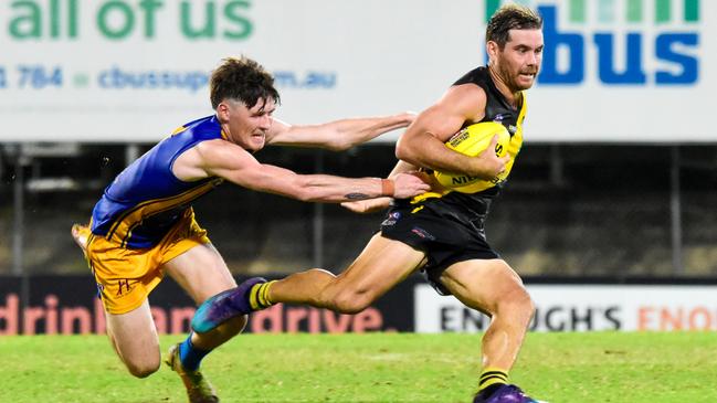 Wanderers' Ankin Lewis tackles Nightcliff's Brodie Filo in Round 9 of the 2022-23 NTFL season. Picture: Tymunna Clements / AFLNT Media