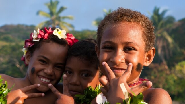 Kids on Makogai Island welcome cruise passengers.