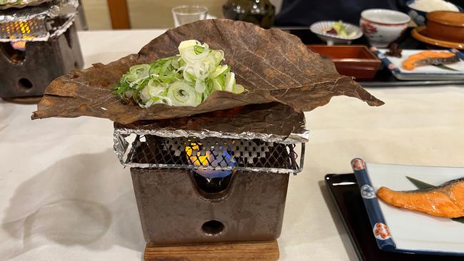 We try our hand at local food traditions, such as cooking on huge heat-resistant magnolia leaves. Picture: Amanda Woods.
