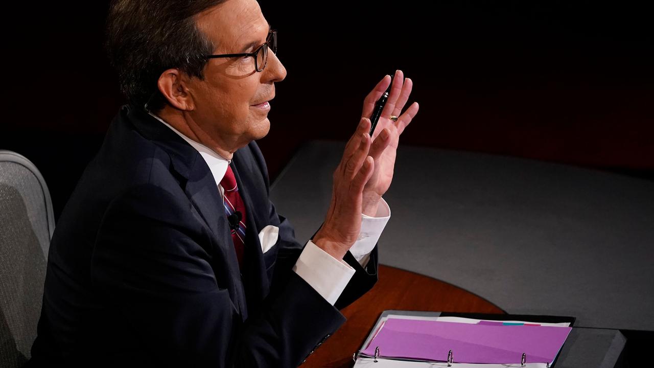 Chris Wallace with his hands raised, pleading for silence. This was a frequent sight during the debate. Picture: Morry Gash/AFP