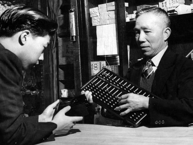 A Chinese shopkeeper using an abacus to tally up the bill in 1947. Picture: HWT Library.