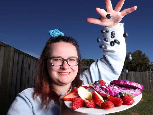 Asthma sufferer Lauren Brook with blue, red and purple foods used to prevent symptoms of exercise-induced bronchoconstriction, Redbank Plains. Picture: Liam Kidston.