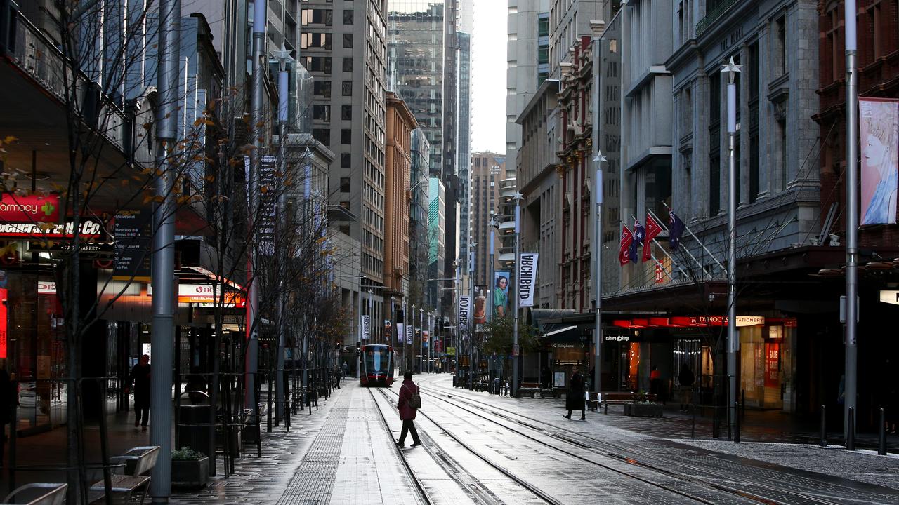 A pedestrian moves along an almost empty George Street in the Sydney CBD on June 28, during stay-at-home orders. Picture: Lisa Maree Williams/Getty Images