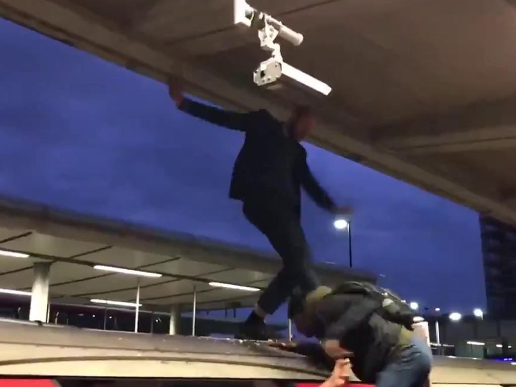 Commuters dragged the protester off the roof of the train. Picture: Supplied