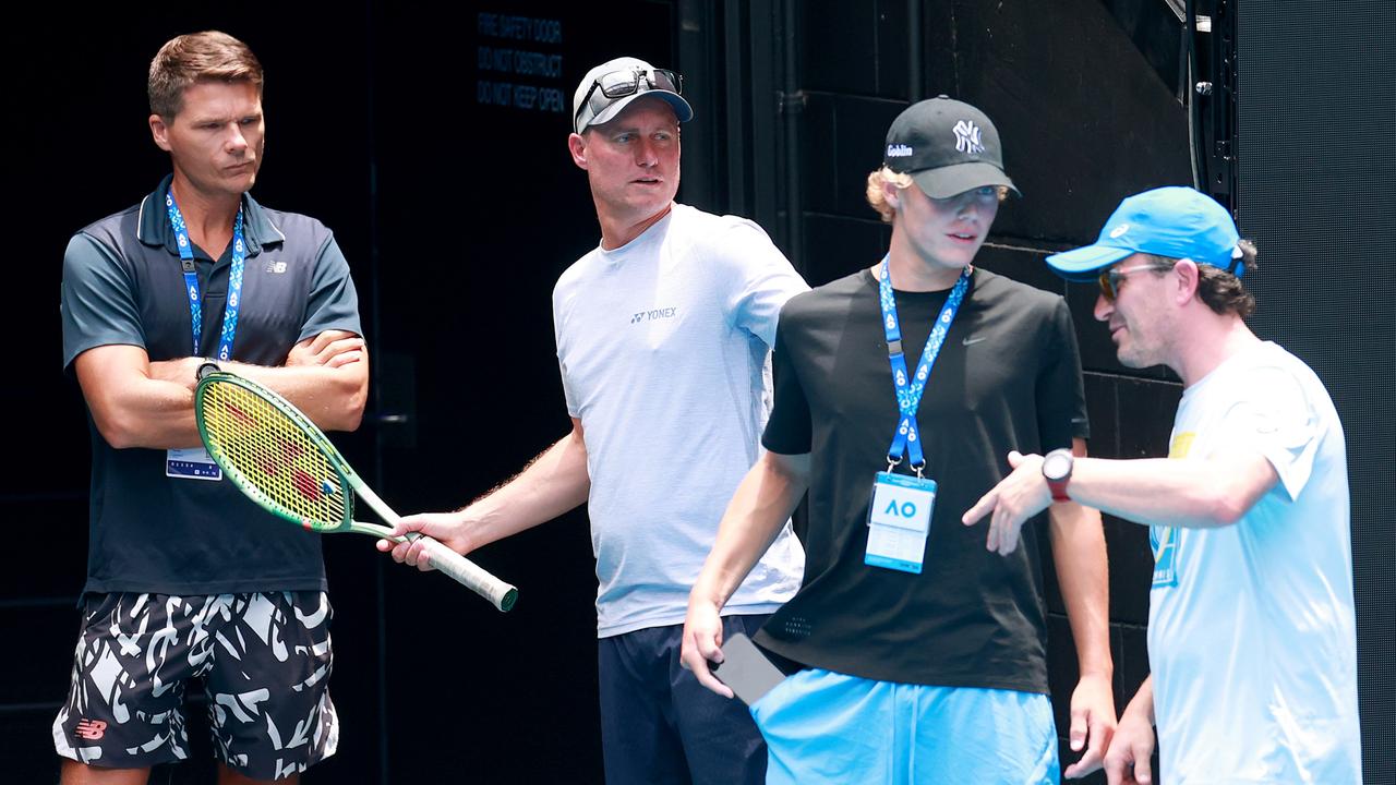 Peter Luczak, Lleyton Hewitt and Cruz Hewitt look on during an Alex de Minaur practice session. (Photo by Kelly Defina/Getty Images)