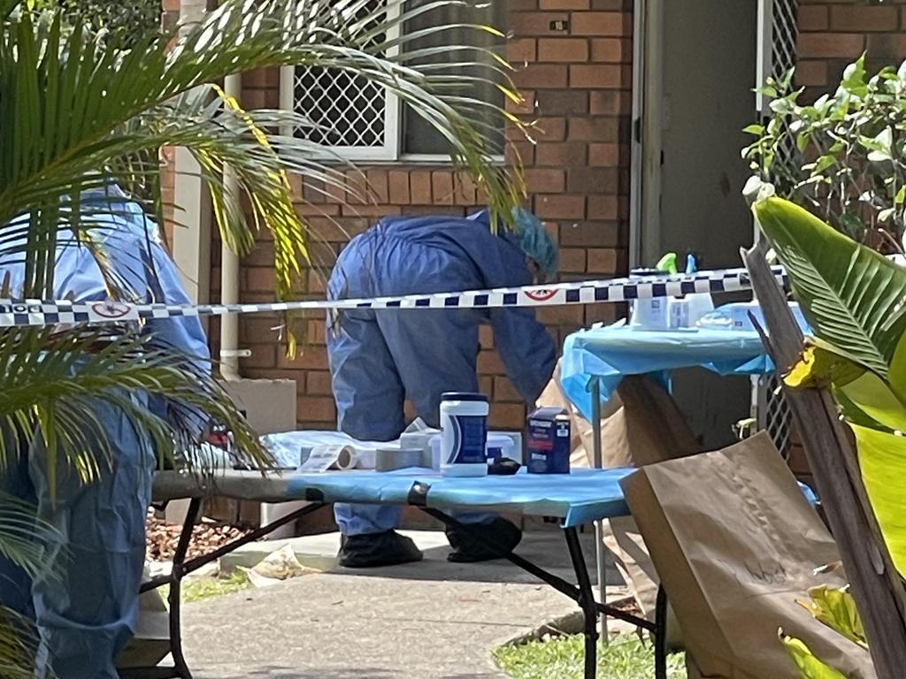 Forensics officers outside the front door of the unit, where a carer allegedly found traces of blood. Picture: Shayla Bulloch