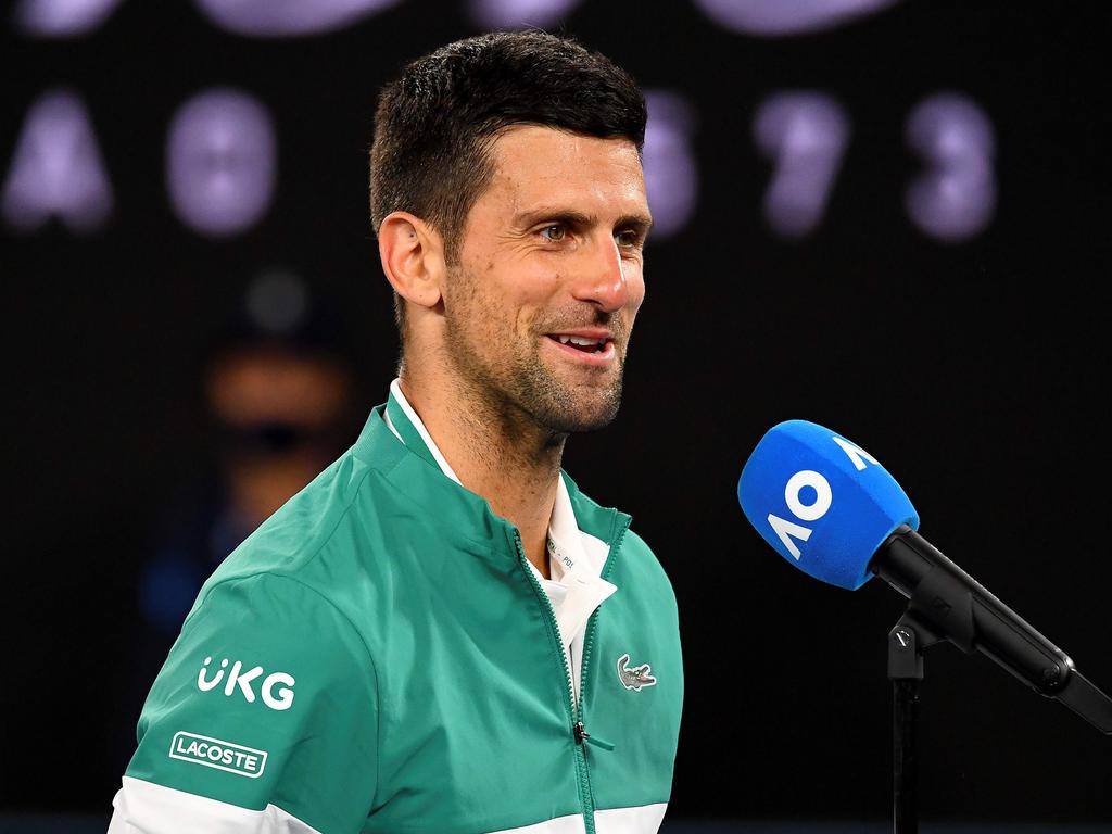 Serbia's Novak Djokovic speaks after celebrating his victory against Canada's Milos Raonic. (Photo by William WEST / AFP)