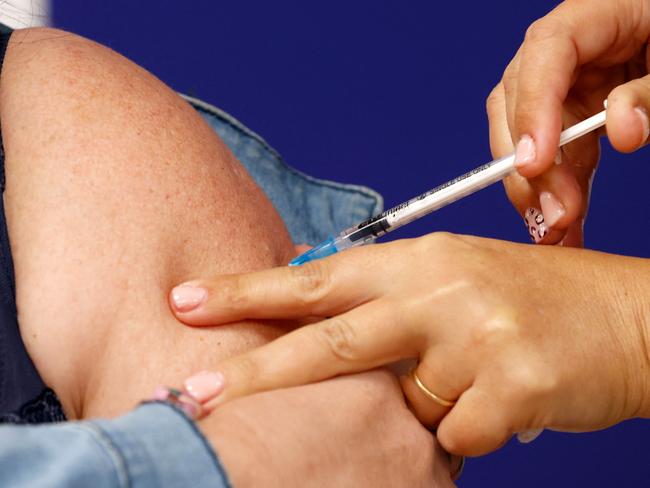 A woman receives her fourth dose of the Pfizer-BioNTech vaccine against the coronavirus, at the outpatient clinics of the cardiovascular centre at Sheba Medical Center in Ramat Gan, near the Israeli coastal city of Tel Aviv,  on December 31, 2021. - Israel started giving fourth Covid vaccine shots today, to people with weakened immunity, becoming one of the first countries to do so, as cases surge driven by the Omicron variant. (Photo by JACK GUEZ / AFP)